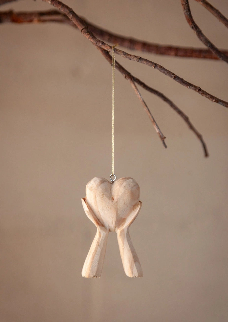Hands Holding Heart Ornaments